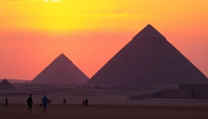 Pyraminds at sunset, showcasing majestic pyramids with tourists in the foreground.