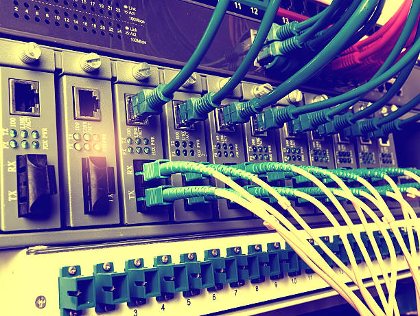 Fiber Optic cables and UTP Network cables connected hub ports.